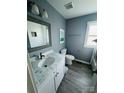 Updated bathroom features marble countertop, framed mirror, ceramic tile, and fresh paint at 2801 Cowles Rd, Charlotte, NC 28208