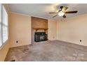 Living room with brick fireplace and carpet at 701 Robinson Clemmer Rd, Dallas, NC 28034