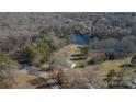 Aerial view of property showcasing a house near a lake and lush trees at 2379 Justin Dr, York, SC 29745