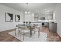 Eat-in kitchen featuring a large island, modern appliances, and a dining area with contemporary decor at 5215 Hatcher Creek Rd # 40, Charlotte, NC 28215