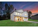 Two-story white house with a brick base, two-car garage, and landscaped lawn at 5240 Carden Dr, Charlotte, NC 28227
