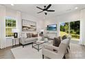 Bright living room with comfy seating, large windows, and sliding glass doors at 5240 Carden Dr, Charlotte, NC 28227