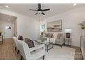 Living room with a neutral color scheme, comfortable seating, and access to hallway at 5240 Carden Dr, Charlotte, NC 28227