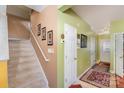 Entryway with staircase, light green walls, and patterned rug at 5927 Pisgah Way, Charlotte, NC 28217
