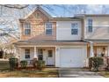 Two-story townhome with neutral siding, attached garage, and small front porch at 5927 Pisgah Way, Charlotte, NC 28217