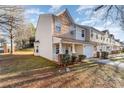 Tan and brown two-story townhome with a brick porch and landscaping at 5927 Pisgah Way, Charlotte, NC 28217