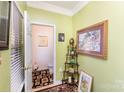 Small powder room with green walls and framed artwork at 5927 Pisgah Way, Charlotte, NC 28217
