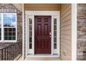 Elegant dark-red front door with sidelights and stone accents at 5941 Gilchrist Cir, Belmont, NC 28012