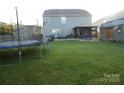 Large backyard with a hot tub, shed, and trampoline at 11677 Striker Ln, Midland, NC 28107