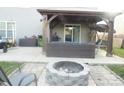 Backyard featuring an outdoor living area with a covered patio and fire pit at 11677 Striker Ln, Midland, NC 28107