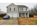 Two-story house with a two-car garage and a landscaped yard at 11677 Striker Ln, Midland, NC 28107