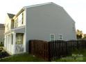 Side view of a two-story home with a fenced yard at 11677 Striker Ln, Midland, NC 28107