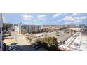 Cityscape view featuring condos, a full parking lot, commercial buildings, and a clear blue sky with some clouds at 2338 Yadkin Ave # 505, Charlotte, NC 28205