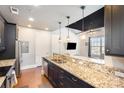 Granite kitchen island with sink and stainless steel appliances at 2338 Yadkin Ave # 505, Charlotte, NC 28205