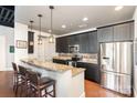 Modern kitchen featuring stainless steel appliances, granite countertops, and a breakfast bar with seating at 2338 Yadkin Ave # 505, Charlotte, NC 28205