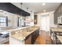 Modern kitchen with granite countertops and dark cabinets at 2338 Yadkin Ave # 505, Charlotte, NC 28205