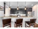 Kitchen bar with granite countertops, dark wood cabinetry, stainless appliances and seating for three at 2338 Yadkin Ave # 505, Charlotte, NC 28205