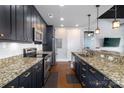 Modern kitchen featuring stainless steel appliances, granite countertops, and dark wood cabinetry at 2338 Yadkin Ave # 505, Charlotte, NC 28205