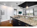 Modern kitchen featuring stainless steel appliances, granite countertops, and dark wood cabinetry at 2338 Yadkin Ave # 505, Charlotte, NC 28205