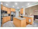 Well-lit kitchen with light wood cabinets, stainless steel appliances, granite countertops, and open layout at 3613 Savannah Way, Monroe, NC 28110