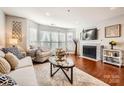 Spacious living room featuring hardwood floors, fireplace, and ample natural light at 509 N Graham St # 2D, Charlotte, NC 28202