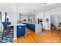 Modern kitchen boasting a large island with blue cabinetry and quartz countertops at 1009 Murandy Ln, Matthews, NC 28104