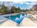 Large rectangular pool with stonework and surrounding landscaping at 1009 Murandy Ln, Matthews, NC 28104