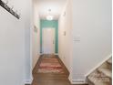 Bright and airy entryway with wood floors and teal accent wall at 195 Hidden Lakes Rd, Statesville, NC 28677