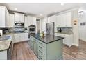 Modern kitchen featuring stainless steel appliances, granite counters, stylish island, and bright white cabinets at 250 Kenway Loop, Mooresville, NC 28117