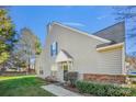 Tan townhouse exterior with brick accents and landscaping at 6078 Bobcat Pl, Charlotte, NC 28269