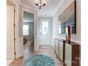 Elegant entryway with hardwood floors, leading to a bedroom and a view of the backyard at 9835 Quercus Ln, Huntersville, NC 28078