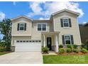 Two story home with neutral siding and a two car garage at 9835 Quercus Ln, Huntersville, NC 28078