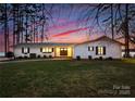 Beautiful lakefront home with a modern exterior and well-manicured lawn at 111 Breezeview Pl, Mooresville, NC 28117