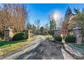 Brick pillars and arched entry gate lead to home at 111 Rapids Run Trl # 17, Iron Station, NC 28080