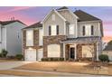 Two-story house with stone accents and a three-car garage at 1265 Reflection Nw Ave, Concord, NC 28027