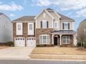 Two-story house with stone accents and a three-car garage at 1265 Reflection Nw Ave, Concord, NC 28027