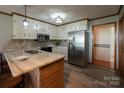 Renovated kitchen, featuring stainless steel appliances and an island at 1544 Daybreak Ridge Rd, Kannapolis, NC 28081