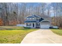 Two-story home with gray siding, a two-car garage, and a landscaped yard at 159 Charles Farm Dr, Cleveland, NC 27013