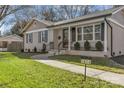 Updated ranch home with walkway and inviting front porch at 1814 Archdale Dr, Charlotte, NC 28210