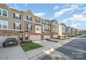 Row of townhouses showcasing architectural details and landscaping at 1907 Catkin Ln, Charlotte, NC 28205