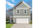 Two-story house, gray siding, white garage door, and a neat lawn at 3008 Sadler Woods Ln, Charlotte, NC 28214