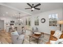 Open concept living and kitchen area with hardwood floors and a view of the backyard at 3016 Sadler Woods Ln, Charlotte, NC 28214