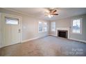 Living room with fireplace and neutral carpeting at 315 W Clairmont St, Troy, NC 27371