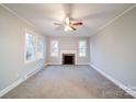 Living room with fireplace and neutral carpeting at 315 W Clairmont St, Troy, NC 27371