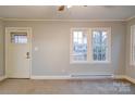 Living room with neutral walls and carpeting at 315 W Clairmont St, Troy, NC 27371