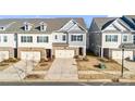 Townhome community view showcasing multiple two-story homes and landscaping at 3323 Glenn Hope Way, Matthews, NC 28104