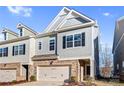 Two-story townhome with gray siding, brick accents, and a two-car garage at 3323 Glenn Hope Way, Matthews, NC 28104