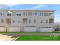 Three-story townhome with attached garage and small lawn at 3705 Lou Ann Ave, Charlotte, NC 28208