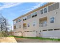 Rear view of townhome showing three-story building with attached garages at 3705 Lou Ann Ave, Charlotte, NC 28208