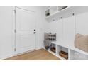 Stylish mudroom featuring built-in shelves, hooks, seating, and modern design at 3705 Lou Ann Ave, Charlotte, NC 28208